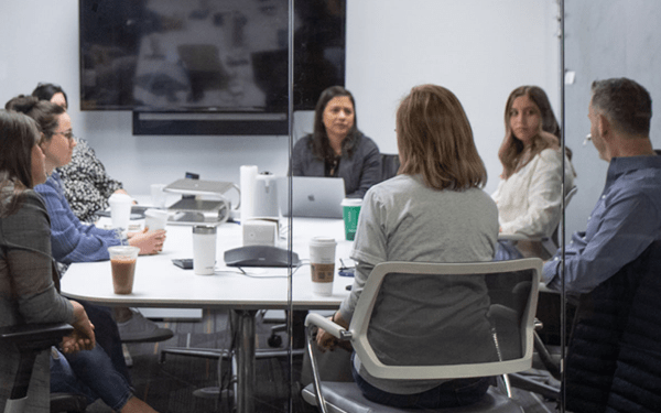 group of employees sitting in conference room