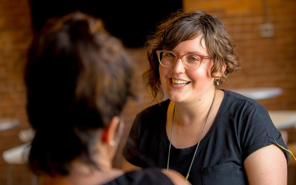 2 women talking happily at work