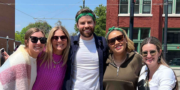 group of 5 employees having fun outside in Cincinnati on a scavenger hunt