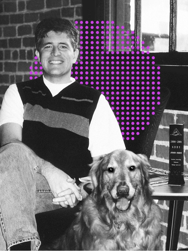 Doug Worple, founder of Barefoot, a brand experience agency, sitting next to his dog